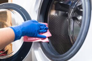 Washing machines are not self-cleaning but taking care of them is quick and easy. Follow these steps to keep your clothes coming out fresh and clean!  Many people aren't aware that regular cleaning of a washing machine is necessary to keep it running efficiently. "It's a washing machine; it cleans itself, right?" Unfortunately, this is not the case! Your washing machine constantly deals with bits of food, clothing fibers, hair, forgotten tissues and chapstick, and whatever else is stuck to (or left in) your clothes.  On top of that, your washing machine's warm, wet world is an ideal environment for mold and mildew to grow. Add in detergent and hard water buildup in hard-to-reach areas well; you're starting to see the picture. Cleaning your washing machine is not difficult or time-consuming. All it takes is a few common household materials, and if you do this regularly, it will get easier every time. Cleaning a Front Loader Materials: Baking Soda White Vinegar Rag Toothbrush Step 1: The first step is to clean all the areas you can reach with a rag or toothbrush dipped in vinegar. This includes the door, the window, the seal, the inside of the drum, and all the nooks and crannies you can get to. Make sure that you use a soft fabric not to scratch the enamel or glass. For filthy areas, create a paste with the baking soda by mixing it with the vinegar in a small dish, or sprinkle it where needed. This will act as a mild abrasive and help remove stuck-on grime. The paste is handy when using the toothbrush to clean the rubber seal around the glass.  Step 2: Fill the liquid detergent dispenser with 1 – 2 cups of vinegar. This will break down any hard water and detergent buildup while simultaneously disinfecting your machine. Set your device on the sanitize cycle (or the hottest cycle on your machine), the full-load setting, and run it empty.  Step 3:  When that cycle is finished, add 1/3 cup of baking soda to the drum. Just pour it right in and then run the machine on hot again. This will prevent any lingering odors and help break down any residual grime that the vinegar didn't wash away.  You do not add the vinegar and baking soda in the same cycle because vinegar is an acid and baking soda a base, and they will neutralize each other. So it won't damage your machine, but it will reduce the cleaning benefits that each provides.  Once these steps are clean, your machine is good to go. I recommend running this cleaning process once a month to ensure that your clothes are left smelling clean and fresh.  Cleaning a Top Loader Cleaning a top loader is quicker than cleaning a front loader because the door is more out of the way. Also, because water is not sloshing against it while running a clothes cycle, it is less likely to accumulate the mold and grime that a front loader does. Other than that, the process is very similar.  Materials: Baking Soda White Vinegar Rag Toothbrush Step 1: When cleaning a top loader, the first step is to fill your machine with hot water. To do this: Start a cycle and then interrupt it halfway through. Add 3 cups of vinegar to the basin and stir to mix it with the water. Let this mixture sit for one hour to give it time to break down any grime that is in the basin. Step 2: While you are waiting, dip your rag and toothbrush into the water and use this to clean the area around the door. If you need extra scrubbing power, you can create a paste with the baking soda or sprinkle it around. Make sure to keep the baking soda from spilling over into the drum, as the chemical properties of baking soda and vinegar will cancel out their cleaning ability.  You can also use a spray bottle filled with vinegar. This helps reach gaskets deep into the detergent and bleach dispensers and the machine's exterior.  If your machine has any removable parts, you can soak these in the vinegar bath while you clean the outside.  Step 3: Run a complete cycle when the exterior has been cleaned, and the mixture has soaked for an hour. This will thoroughly clean the areas of the machine that you can't get to and rinse away the vinegar. Once finished, leave the door open for the inside to dry out. Steps For a Very Dirty Washing Machine Sometimes, vinegar and baking soda won't be strong enough to get your machine as clean as you want it. This might be the case if you hadn't washed your device before or moved into a new home and want to start fresh. Step 1: If this is the case, fill your washer with hot water and add a quart of bleach. Next, start the machine and let it run for one minute to mix things up, then open the top and let it soak for one hour. After it has soaked, close the lid and run your machine on a complete cycle. The device will drain the bleach and rinse any residue left behind. Once finished, you will repeat this cycle but with vinegar.  Step 2: Fill your washer with hot water and add a quart of white vinegar to the water and into the bleach compartment. Let the machine run for a minute to agitate the mixture and then lift the lid and let it sit for an hour. When the hour is up, run a complete cycle, and your machine will be fresh and clean! Tips: When not using your washing machine, always leave the door open to dry out thoroughly. This will go a long way in preventing mildew and mold buildup and keep things smelling fresh. Never leave wet clothes in the washer! Instead, transfer them immediately into the dryer or hang them on a drying rack. 